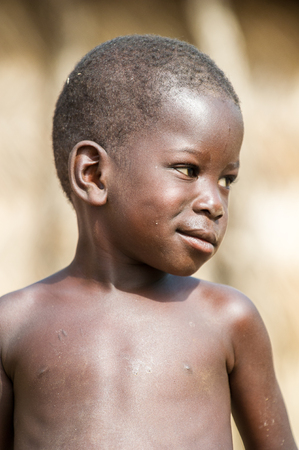 ACCRA, GHANA - MARCH 6, 2012: Unidentified Ghanaian boy smiles in the street in Ghana. Children of Ghana suffer of poverty due to the unstable economic situationのeditorial素材