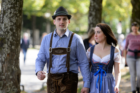 MUNICH, GERMANY - OCT 2, 2017: Unidentified couple in traditional Bavarian costume goes to the Octoberfest,  the world's largest beer festivalのeditorial素材