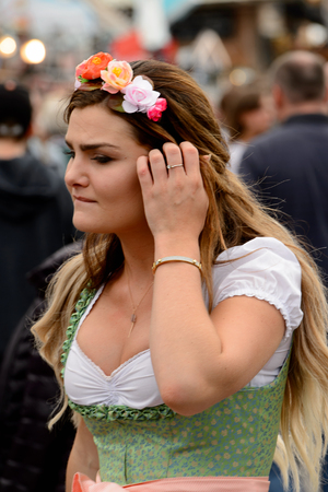 MUNICH, GERMANY - OCT 2, 2017: Unidentified girl in traditional Bavarian costume at the Octoberfest,  the world's largest festivalのeditorial素材