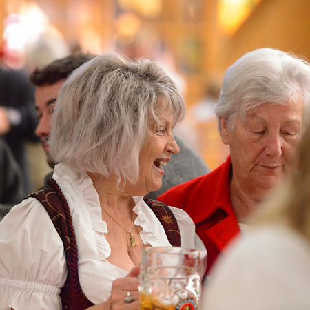 MUNICH, GERMANY - OCT 2, 2017: Unidentified old lady in traditional Bavarian costume drinks beer at the Octoberfest,  the world's largest festivalのeditorial素材