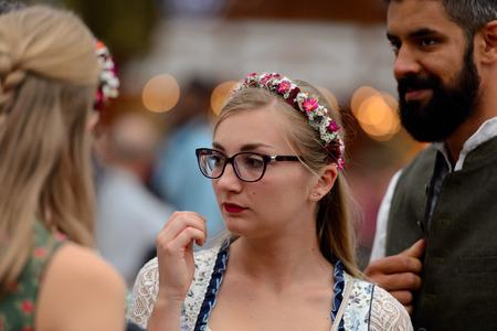 MUNICH, GERMANY - OCT 2, 2017: Unidentified beautiful girl in traditional Bavarian costume at the Octoberfest,  the world's largest festivalのeditorial素材