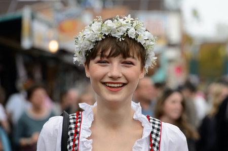 MUNICH, GERMANY - OCT 2, 2017: Unidentified beautiful young girl in traditional Bavarian costume at the Octoberfest,  the world's largest festivalのeditorial素材