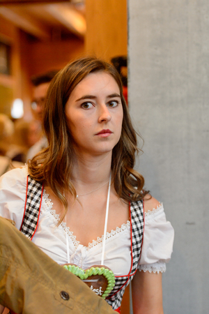 MUNICH, GERMANY - OCT 2, 2017: Unidentified girl in traditional Bavarian costume at the Octoberfest,  the world's largest festivalのeditorial素材