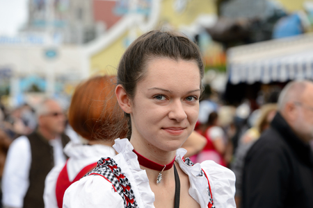MUNICH, GERMANY - OCT 2, 2017: Unidentified beautiful young girl in traditional Bavarian costume at the Octoberfest,  the world's largest festivalのeditorial素材