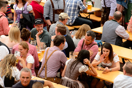 MUNICH, GERMANY - OCT 2, 2017: Unidentified people drink beer at the Octoberfest,  the world's largest festivalのeditorial素材