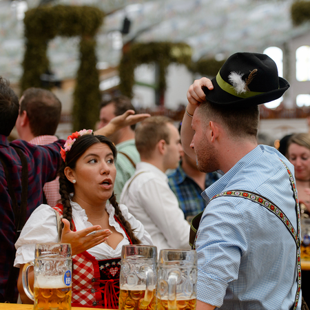 MUNICH, GERMANY - OCT 2, 2017: Unidentified friends drink beer at the Octoberfest,  the world's largest festivalのeditorial素材