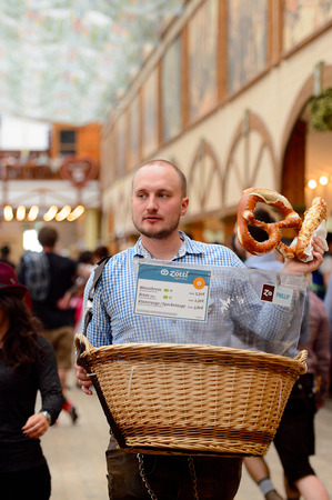 MUNICH, GERMANY - OCT 2, 2017: Unidentified man serves bread at the Octoberfest,  the world's largest festivalのeditorial素材