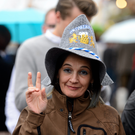 MUNICH, GERMANY - OCT 2, 2017: Unidentified woman in a hat at the Octoberfest,  the world's largest festivalのeditorial素材