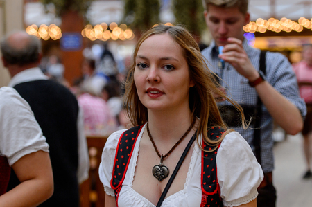 MUNICH, GERMANY - OCT 2, 2017: Unidentified girl in traditional Bavarian costume at the Octoberfest,  the world's largest festivalのeditorial素材