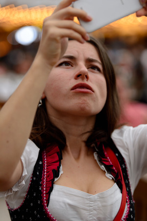 MUNICH, GERMANY - OCT 2, 2017: Unidentified girl in traditional Bavarian costume at the Octoberfest,  the world's largest festivalのeditorial素材