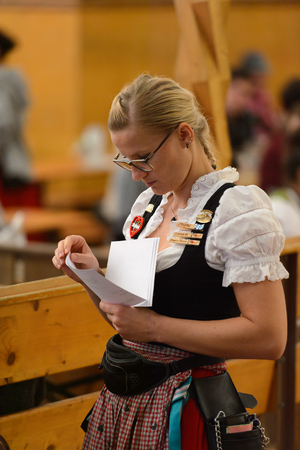 MUNICH, GERMANY - OCT 2, 2017: Unidentified girl in traditional Bavarian costume works at the Octoberfest,  the world's largest festivalのeditorial素材