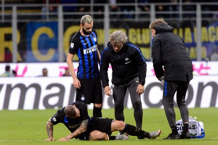 MILAN - OCT 21, 2018: Radja Nainggolan (Inter) gets some help from doctors. FC Internazionale - AC Milan. San Siro stadium. Italian league Serie A.のeditorial素材
