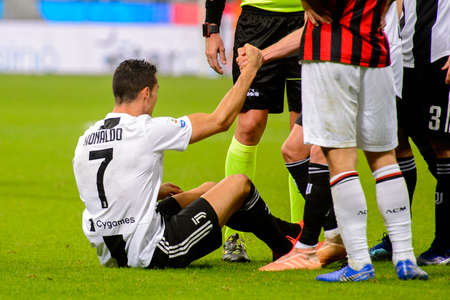 MILAN - NOV 11, 2018: Cristiano Ronaldo 7 is injured on the grass. AC Milan - Juventus. Italian Serie A TIM. Giuseppe Meazza Stadiumのeditorial素材