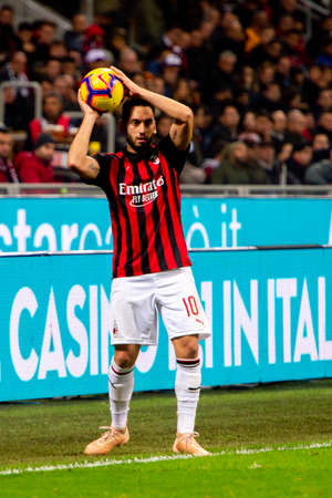 MILAN - NOV 11, 2018: Hakan Calhanoglu 10 throws the ball. AC Milan - Juventus. Italian Serie A TIM. Giuseppe Meazza Stadiumのeditorial素材