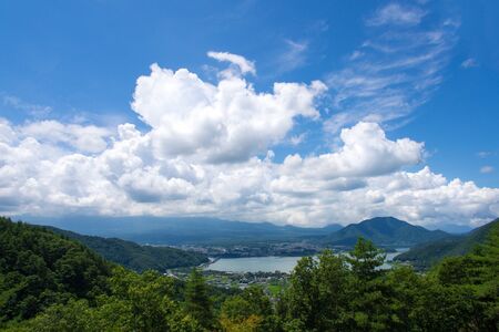 Cumulus Clouds Over a Mountain Lake in Japanの写真素材