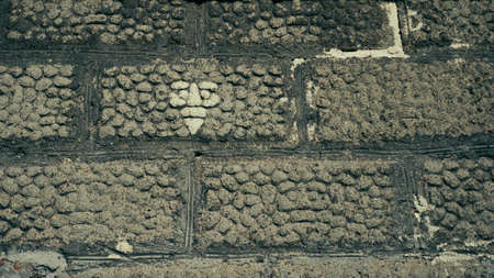 Old wall made of gray hollow bricks
