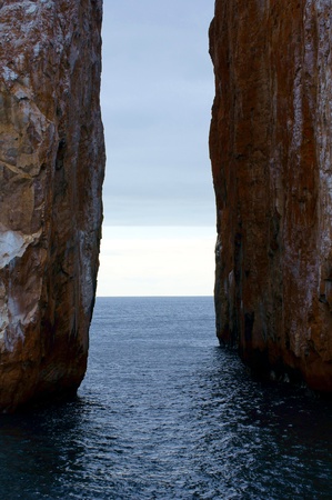 Two rocks jut out of the sea in the Leon Dormida  Sleeping Lion  rock formation in the Galapagos, Ecuador の写真素材