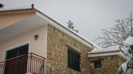 Snow-covered village in the mountains. Winter at Trikala Korinthias, Peloponnese, Greece