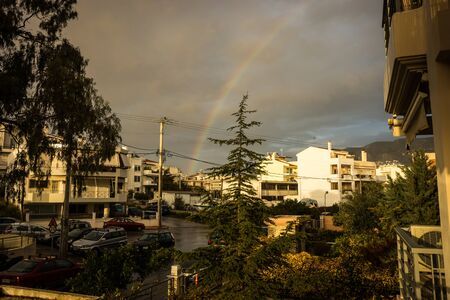 Image of a rainbow over the suburb of Athens, Greeceの写真素材