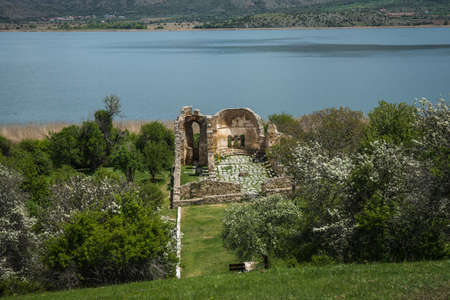 Ruins of church on the island of St. Ahileos at Lake Prespa, Greeceの写真素材