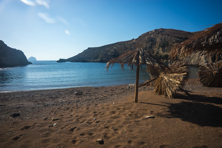 Picturesque sea landscape with umbrellas made of palm leaves, Kythira, Greeceの写真素材