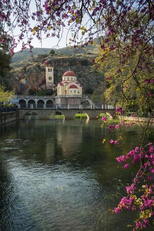 Image of Church under the rock, river and flowers