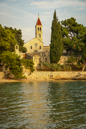 Image of a church near the sea at Sunset at Bol, Brac, Croatiaの写真素材