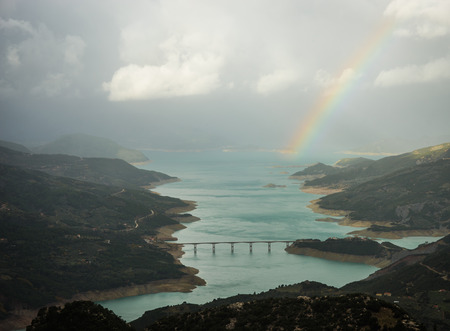 Scenic view from the mountain to the lake and rainbow, Evitania, Greeceの写真素材