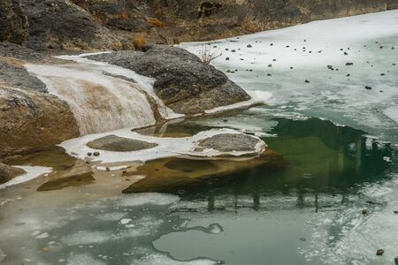 Image of river with green waters, snow and ice near Meteora in Greeceの写真素材
