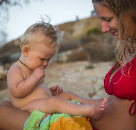 Image of a boy peeing on his mother on the beach, Greeceの写真素材