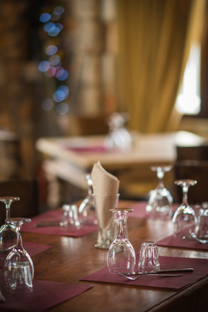 Image of wine glasses on a wooden table in a festive lightの写真素材