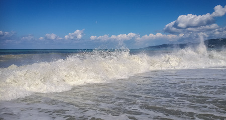 High wave with cloud of splash on beach in Sochi, Russia