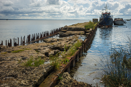 Ruins of   wharf of times of World War 2 near base of Noitif on Baltic Spit in Kaliningrad Region, Russiaの写真素材