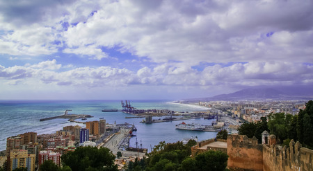 Scenic cloudy view to Malaga from hill in Spainの写真素材