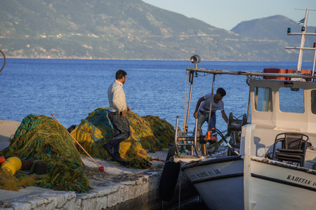 Fiskardo, Greece - April 30, 2016, Fishermen on  pier of  town of Fiscardo on island of Kefalonia in Greeceのeditorial素材