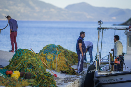 Fiskardo, Greece - April 30, 2016, Fishermen on  pier of  town of Fiscardo on island of Kefalonia in Greeceのeditorial素材