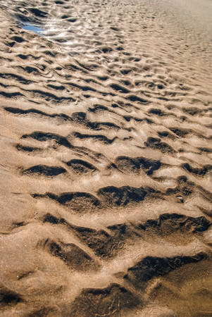 Image of light and shadows on  sand on the beach in Portugal