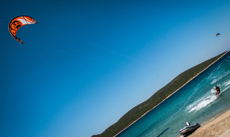 Golden beach at Marmari, Greece - June 24, 2012, Sky-surfers playing on Golden beach in Marmari on Evia island in Greece in  Greeceのeditorial素材
