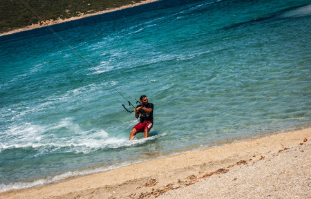 Golden beach at Marmari, Greece - June 24, 2012, Sky-surfers playing on Golden beach in Marmari on Evia island in Greece in  Greeceのeditorial素材