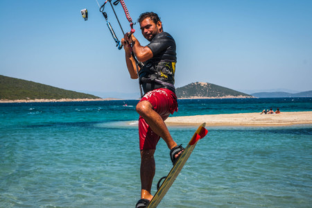 Golden beach at Marmari, Greece - June 24, 2012, Sky-surfers playing on Golden beach in Marmari on Evia island in Greeceのeditorial素材