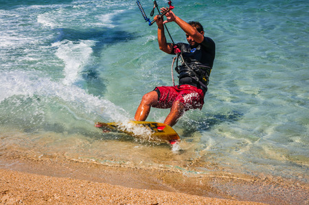 Golden beach at Marmari, Greece - June 24, 2012, Sky-surfers playing on Golden beach in Marmari on Evia island in Greeceのeditorial素材