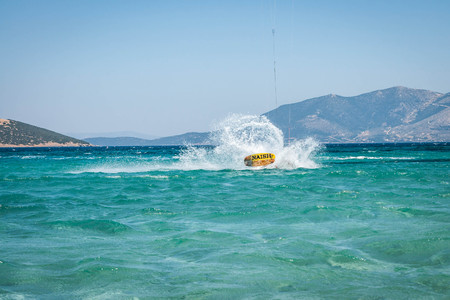 Golden beach at Marmari, Greece - June 24, 2012, Sky-surfers playing on Golden beach in Marmari on Evia island in Greeceのeditorial素材