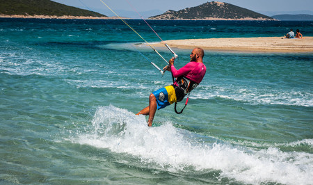 Golden beach at Marmari, Greece - June 24, 2012, Sky-surfers playing on Golden beach in Marmari on Evia island in Greeceのeditorial素材