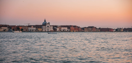 Scenic image of picturesque chanels of Venice at sunset in Italyの写真素材