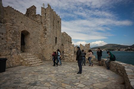 Burdzi, Greece - April 12, 2014, People on ruins of  fortress on Bourtzi island in Greece