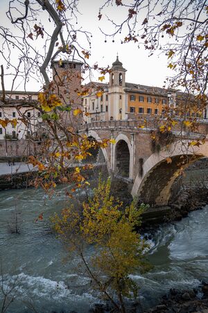Cityscape with bridge over the Tiber river and Tiberina island in Rome in Italyの写真素材