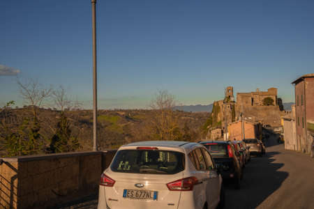 Celleno, Italy - March 08, 2020, Cars on the streets of Ghost town of Celleno at sunset in Lazio in Italyのeditorial素材
