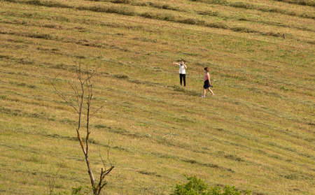Rome, Italy - May 05, 2020, Masked people on a newly plowed field during self-isolation in Italyのeditorial素材