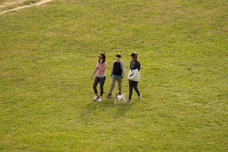 Rome, Italy - May 05, 2020,  People walking with dog in a meadow during self-isolation in Rome, Italyのeditorial素材