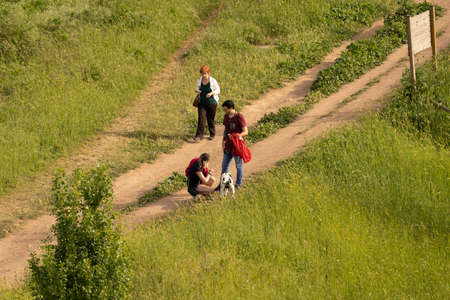 Rome, Italy - May 05, 2020,  People walking with dog in a meadow during self-isolation in Rome, Italyのeditorial素材